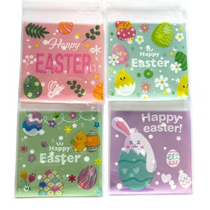 May include: Four clear plastic bags with Easter-themed designs. The bags are decorated with colourful eggs, flowers, bunnies, and chicks. The text on the bags reads "Happy Easter" and "Happy easter!"