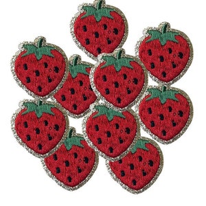 May include: Nine embroidered iron-on patches of red strawberries with green leaves and black seeds.