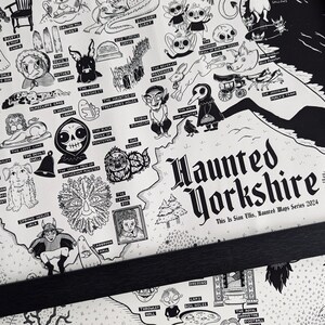 May include: A black and white illustrated map of haunted locations in Yorkshire, England. The map features various spooky creatures and landmarks, including a black cat, a ghost, a skull, and a tree with a face. The text "Haunted Yorkshire" is written in a bold, gothic font at the bottom of the map.