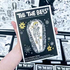 May include: A black and white zine titled Tell The Bees, featuring a skeleton wearing a crown inside a coffin, surrounded by yellow and white flowers. The cover text reads A catalogue of bizarre tales from Folklore, Fiction and History, Issue 12.