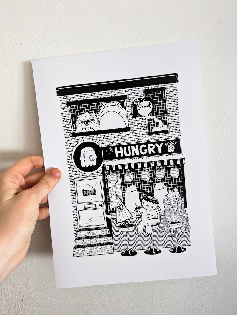 May include: Black and white illustration of a ghost-themed restaurant called "The Hungry Ghost". The restaurant has a brick facade with windows and a door. There are ghosts and other creatures sitting at tables outside the restaurant.