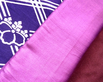 May include: Three fabric swatches in different colors and textures. The top swatch is a dark purple with a white floral pattern. The middle swatch is a bright pink. The bottom swatch is a deep burgundy.