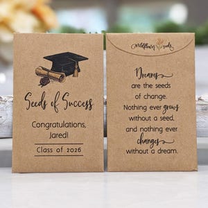 May include: Two brown seed packets. One features a graduation cap and scroll with the text "Seeds of Success," "Congratulations, Jared!" and "Class of 2026." The other reads "Dreams are the seeds of change."