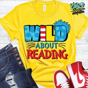 May include: Yellow t-shirt with the text "WILD ABOUT READING" in colorful, playful letters. The letters are decorated with red, white, and blue stripes and blue polka dots.