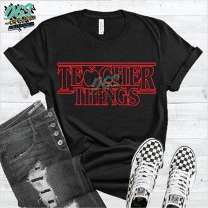 May include: Black t-shirt with a red graphic that says "Teacher Things" in a style reminiscent of the Netflix show "Stranger Things".