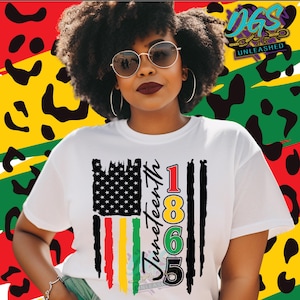 May include: White t-shirt with a Juneteenth graphic. The design incorporates a stylized American flag, black and coloured stripes, the text "Juneteenth 1865", and a leopard print background in red, yellow, and green.