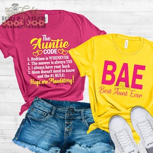 May include: Two t-shirts, one pink and one yellow, with text. The pink shirt says "The Auntie Code" and lists rules for being an aunt. The yellow shirt says "BAE Best Aunt Ever".