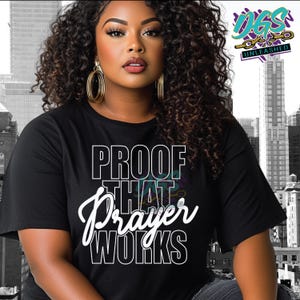 May include: A black t-shirt with white text that reads "PROOF THAT PRAYER WORKS".