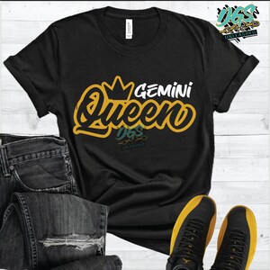 May include: Black t-shirt with a yellow graphic that says "Gemini Queen" with a crown above the word "Queen".