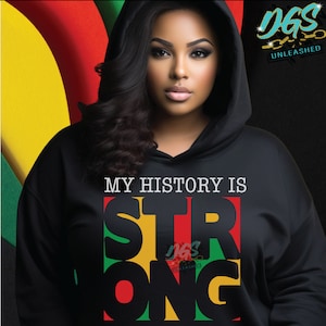 May include: Black hoodie featuring the text "MY HISTORY IS STRONG" in red, yellow and green lettering. The letters are stacked on top of each other with the word "STRONG" in a larger font size. The hoodie is being worn by a person with dark hair and dark skin.
