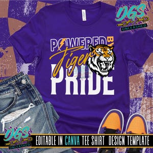May include: Purple t-shirt with the words "POWERED BY Tiger PRIDE" in white and yellow. A tiger graphic is on the right side. The text "EDITABLE IN CANVA TEE SHIRT DESIGN TEMPLATE" is at the bottom.