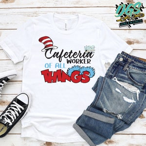 May include: White t-shirt with a red and white hat and the text "Cafeteria Worker of all Things" in red and blue letters.