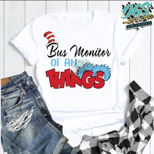 May include: White t-shirt with a red and blue graphic that says "Bus Monitor of All Things" with a red and white hat on top of the word "Things".