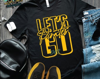 May include: Black t-shirt with the words "Let's Pirates Go" in yellow lettering.