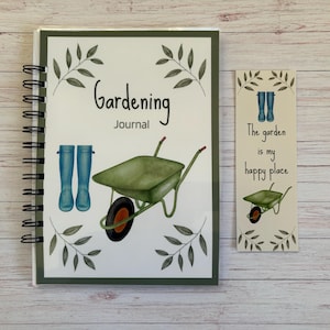 May include: A gardening journal and bookmark set. The journal has a spiral binding and a cover with a green wheelbarrow, blue wellington boots, and the words "Gardening Journal". The bookmark says "The garden is my happy place."