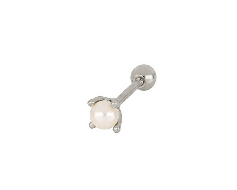 May include: A silver barbell earring with a white pearl on the end.