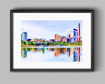 Puede incluir: Pintura a la acuarela de un paisaje urbano con edificios y una masa de agua que refleja el horizonte. La obra de arte está enmarcada en un marco negro, con un cielo azul claro y una colorida variedad de edificios.