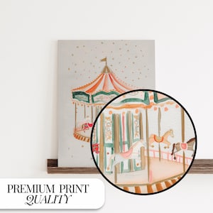 May include: A watercolour painting of a vintage carousel with horses and a striped canopy. The carousel is painted in shades of pink, orange, green, and brown. The background is a light grey with white dots.