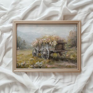 May include: A vintage-style painting of a wooden wagon filled with white and pink flowers. The wagon is on a dirt road with green grass and trees in the background.