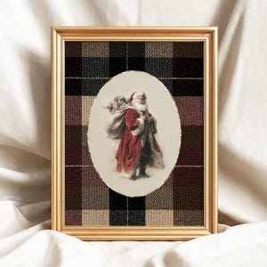 May include: A framed print featuring Santa Claus carrying a sack of gifts. The image of Santa is in an oval shape, set against a plaid background of black, brown, and burgundy. The frame is gold-colored.