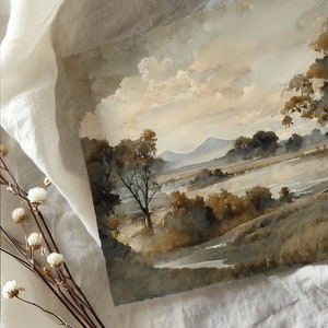 May include: A watercolor painting of a landscape with a river, trees, and mountains in the background. The sky is a light blue with white clouds. The painting is done in shades of brown and gray.