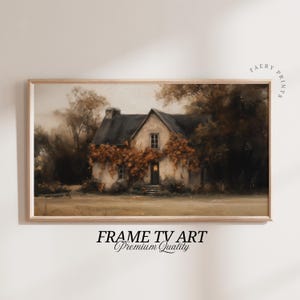 May include: A framed print depicting a rustic cottage with a dark roof, set amongst autumnal trees and foliage in brown and gold tones. The artwork is labeled "FRAME TV ART Premium Quality."