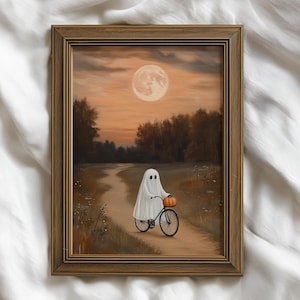 Pode incluir: Pintura emoldurada que retrata uma cena de Halloween. Um fantasma branco em uma bicicleta preta carrega uma abóbora laranja. O fundo apresenta uma lua cheia, árvores e um céu alaranjado.