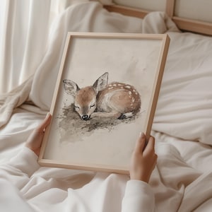 May include: A watercolour painting of a fawn asleep on a bed of leaves. The fawn is brown with white spots and has its eyes closed. The painting is done in a soft, muted palette.