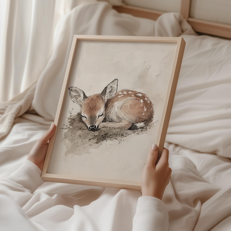 May include: A watercolour painting of a fawn asleep on a bed of leaves. The fawn is brown with white spots and has its eyes closed. The painting is done in a soft, muted palette.