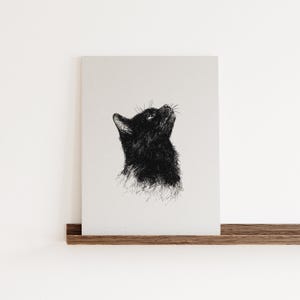 May include: A black and white line drawing of a cat looking up. The cat is drawn in a realistic style with detailed fur.