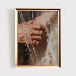 May include: A close-up of two hands intertwined, with a gold ring on one finger. The hands are partially obscured by a sheer white fabric, creating a romantic and ethereal feel.