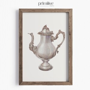 May include: A silver teapot with an ornate design and a lid. The teapot is on a white background.