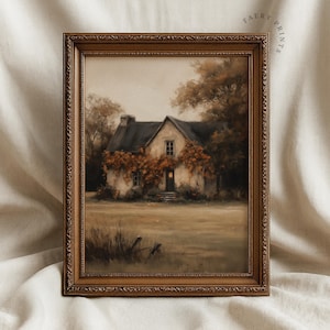 May include: A framed print of a quaint cottage scene. The artwork depicts a white cottage with a dark roof, surrounded by autumn foliage. The print is in a decorative brown frame, with the text "FAERY PRINTS" in the upper right corner.