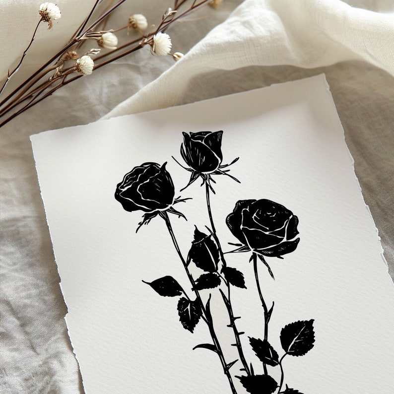 May include: Black and white line art print of three roses with stems and leaves.