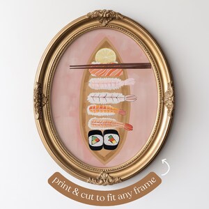 May include: A gold oval frame with a pink background and a painting of sushi and shrimp. The sushi is in a boat shape and has a lemon slice on top. The shrimp are arranged vertically in a row. The text "print & cut to fit any frame" is at the bottom of the image.