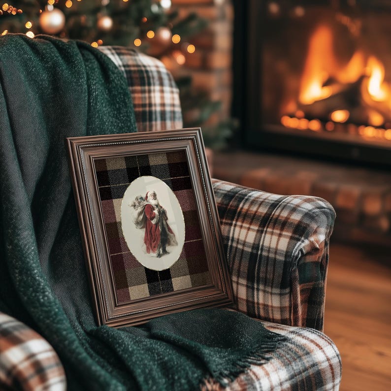 May include: A framed vintage print featuring a couple in a red and brown coat, set against a plaid background. The frame is brown, and the print is resting on a plaid armchair with a green blanket. A Christmas tree and fireplace are in the background.