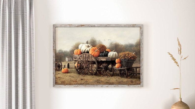 May include: A vintage wooden wagon filled with a variety of pumpkins, including orange, white, and green pumpkins. The wagon is in a field with fall foliage and a rustic wooden fence in the background.