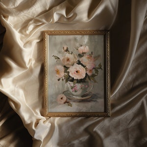 May include: A framed oil painting of a bouquet of pink roses in a vintage teacup. The roses are arranged in a delicate cluster, with their petals unfurling in a soft, romantic style. The teacup is painted with a floral pattern and sits on a saucer.