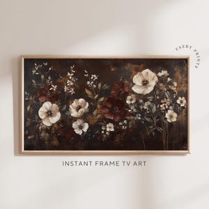 May include: A framed print of a floral painting with white and burgundy flowers on a dark brown background. The flowers are arranged in a cluster and have a vintage aesthetic.