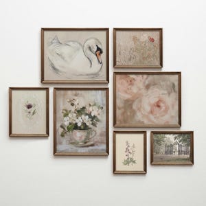 May include: A collection of framed art prints in various sizes and styles. The artwork includes a swan, floral arrangements, and botanical illustrations. The frames are a warm, antique gold color, creating a cohesive gallery wall aesthetic.