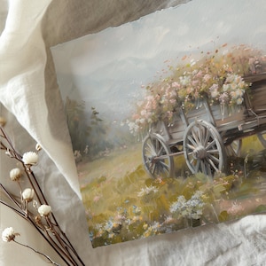 May include: A vintage wooden wagon filled with a bouquet of white and pink flowers. The wagon has two large wheels and is set against a soft, hazy background of rolling hills and a blue sky.