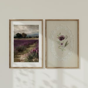 May include: Two framed art prints. The left print depicts a lavender field with a path, under a cloudy sky. The right print features a floral design within a lace oval frame. Both prints are in wooden frames.