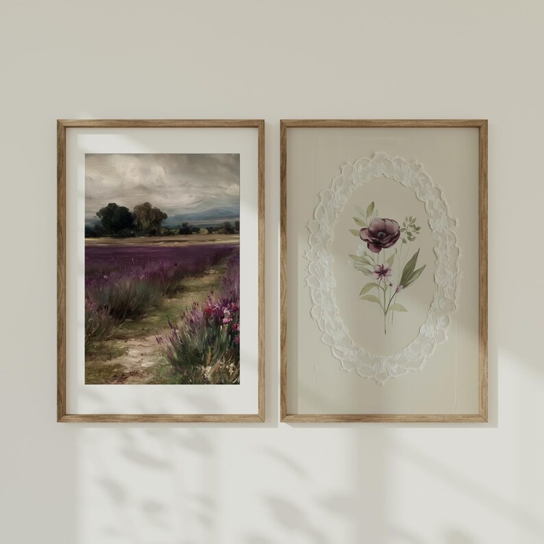 May include: Two framed art prints. The left print depicts a lavender field with a path, under a cloudy sky. The right print features a floral design within a lace oval frame. Both prints are in wooden frames.