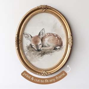 May include: A watercolour painting of a fawn sleeping in a woodland setting. The fawn is brown with white spots and is lying on its side with its head resting on its paws. The painting is framed in a gold oval frame.