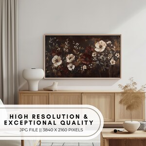 May include: A digital print of a floral arrangement with white and red flowers on a dark background. The print is framed and hanging on a wall above a wooden cabinet.