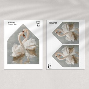 May include: Printable envelope liner featuring a watercolour painting of two white swans with their heads touching. The swans are on a light blue background with a subtle watercolour effect.
