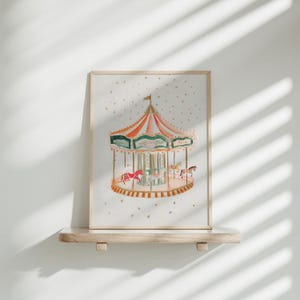 May include: A framed watercolour painting of a vintage carousel with colourful horses and a gold trim. The carousel is set against a white background with gold glitter.