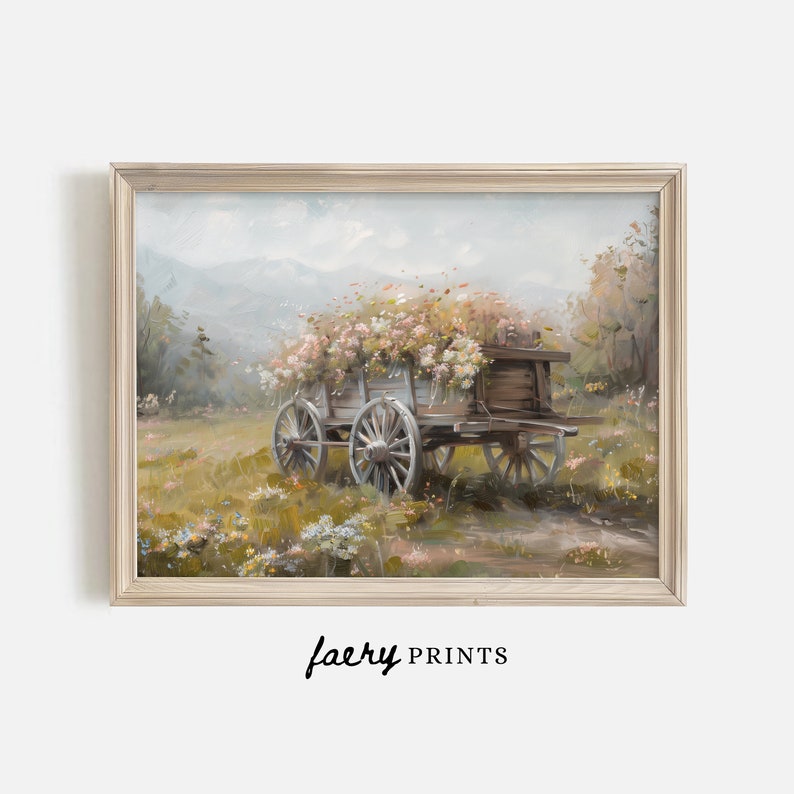 May include: A vintage wooden wagon filled with pink and white flowers, parked in a field with green grass and a mountain range in the background. The wagon has wooden wheels and a wooden frame.