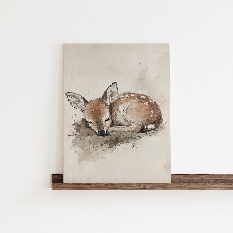 May include: A watercolour painting of a fawn sleeping on a bed of leaves. The fawn is brown with white spots and has its eyes closed. The background is a light brown colour.