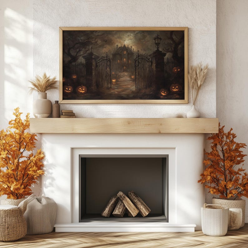 May include: A framed painting of a spooky house with glowing jack-o'-lanterns in front of it, hanging above a fireplace with a wood mantel and a white surround. The fireplace has a black interior and a pile of logs inside.